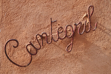 Cantegril metal rusty insignia on ochre wall