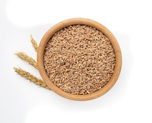 Wooden bowl with spelt grain isolated on white