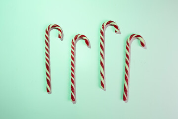 Minimal composition with christmas lollipops on color background, top view