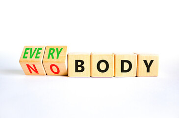Everybody vs nobody symbol. Concept words Everybody and Nobody on wooden cubes. Beautiful white table white background. Business and everybody vs nobody concept. Copy space.