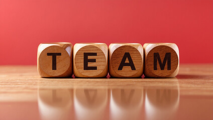  the word team is written on a wooden cubes structure on red background 