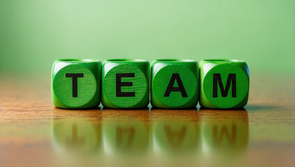  the word team is written on a wooden cubes structure on green background 