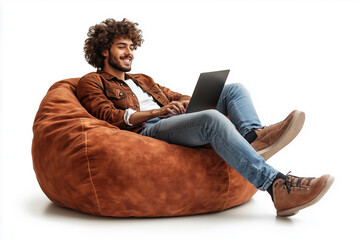 A man is sitting on a bean bag chair and using a laptop. He is smiling and he is enjoying himself. Concept of relaxation and leisure