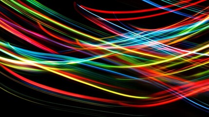 Abstract image of colorful light trails against a dark background.