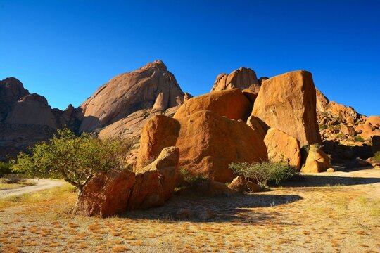 Sunset scenery of Spitzkoppe, "Matterhorn of Namibia" - a group of bald granite peaks located between Usakos and Swakopmund in the Namib desert (Namibia)