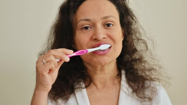 Woman maintaining dental hygiene with toothbrush in domestic setting