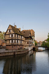 Wooden cute houses on the bank of the river canal Petite France in Strasbourg, France.