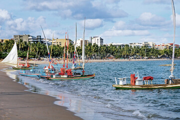 Rafts in Pajuçara Beach, typical sail and rustic boat used for fishing and tourist transportation....