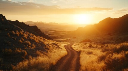 A winding road stretches through a golden landscape as the sun sets behind distant mountains. The warm light casts a tranquil glow over the scenery, creating a peaceful atmosphere