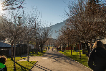 walk in an outdoor park in Andorra with mountains in the background on a sunny day