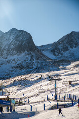 Pas de la Casa ski resort with people skiing in the Pyrenean mountains in Andorra