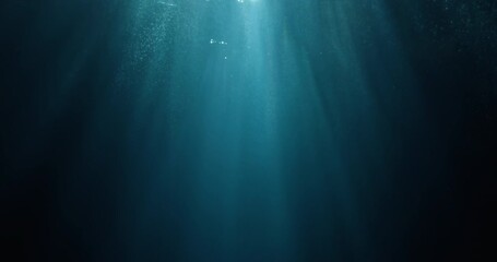 Long high-speed loopable 4K film slow-motion footage of underwater rays piercing ocean surface.  Enchanting beams of light flickering, ideal VFX background for vacation, snorkeling, summer adventures