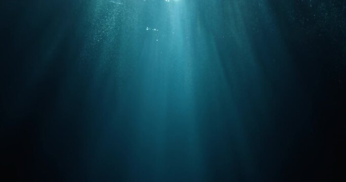 Long high-speed loopable 4K film slow-motion footage of underwater rays piercing ocean surface.  Enchanting beams of light flickering, ideal VFX background for vacation, snorkeling, summer adventures