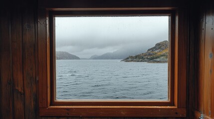 Raindrops on Window Frame Overlooking Calm Sea and Coastal Landscape in Overcast Weather
