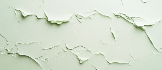 Textured light green background with layered paint detail ideal for showcasing design elements and adding a fresh aesthetic touch.