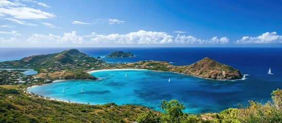 Obraz premium Caribbean island landscape with vibrant blue waters and lush greenery under a bright sky ideal for travel and vacation marketing materials