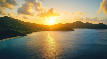 Fototapeta premium Caribbean coastline at sunset with aerial view of turquoise ocean sandy shore and mountains in serene golden light atmosphere