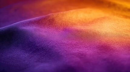 Velvet fabric showcasing soft purple and orange lighting blur for a serene and elegant background texture