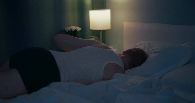 Male falling down on bed and asleep after overloaded hard work. chronic fatigue and employee overtime