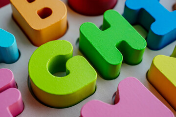 wooden educational letters, scattered letters create a background