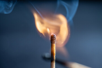 Match stick lighting up on black backgroud.