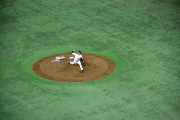 Baseball players in action on a mound, surrounded by green turf, showcasing the intensity and skill of the game. Famous Japanese national sport.
