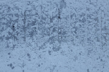 A person riding a snowboard through snowy terrain.