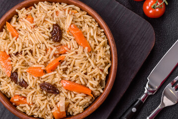 Delicious fresh pilaf with rice, carrots, meat, onions, spices and berries