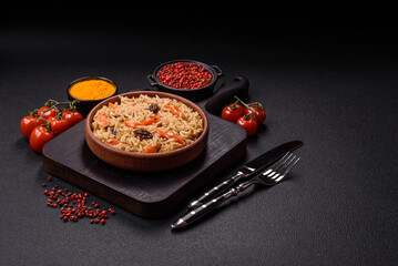 Delicious fresh pilaf with rice, carrots, meat, onions, spices and berries
