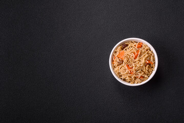 Delicious fresh pilaf with rice, carrots, meat, onions, spices and berries