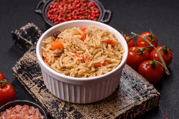 Delicious fresh pilaf with rice, carrots, meat, onions, spices and berries