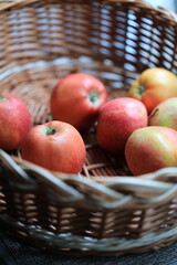 A colorful basket filled with many red and green apples, perfect for snacking or decorating.