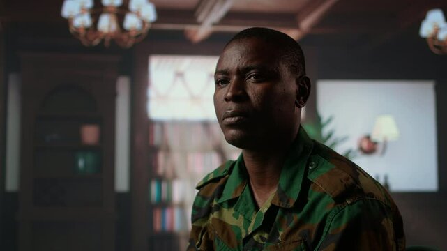 Armed forces trooper deals with depersonalization syndrome due to combat PTSD, feeling distressed and dissociative during therapy session. Black soldier with shell shock and trauma. Camera A.