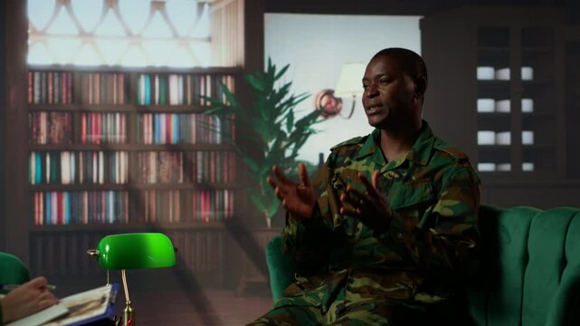 Camouflaged black army trooper meeting with a psychologist at therapy, seeking support for PTSD and trauma recovery. Discussions for armed forces mental health care and counseling. Camera B.