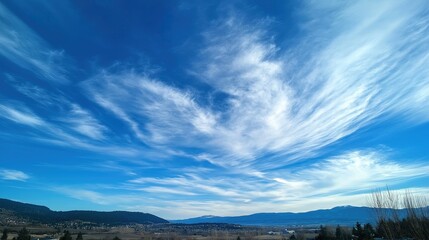 A clear blue sky with a few clouds scattered throughout