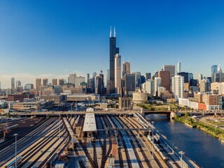 Chicago Union Station, train yard, and city skyline. Aerial view of train tracks and commuter rail...