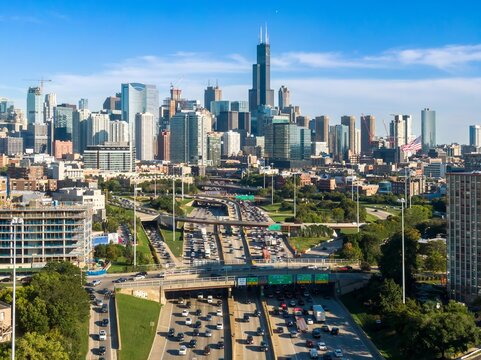 Chicago skyline and highway traffic. Busy interstate with numerous vehicles, construction, and city buildings. Elevated view. Kennedy Expressway, Chicago, Illinois, United States