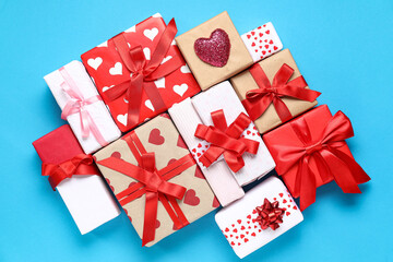 Different gift boxes with hearts and red ribbons on blue background. Valentine's Day celebration
