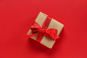Gift box with ribbon on red background. Valentine's Day celebration