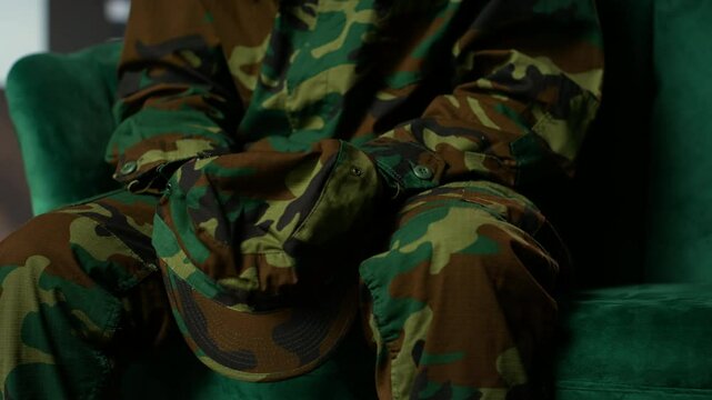 Armed forces trooper deals with depersonalization syndrome due to combat PTSD, feeling distressed and dissociative during therapy session. Black soldier with shell shock and trauma. Camera B.