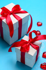 Composition with gift boxes and hearts for Valentine's Day celebration on blue background, closeup