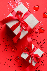 Composition with gift boxes and confetti for Valentine's Day celebration on red background