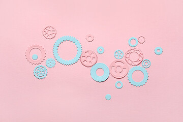 Different paper gears on pink background