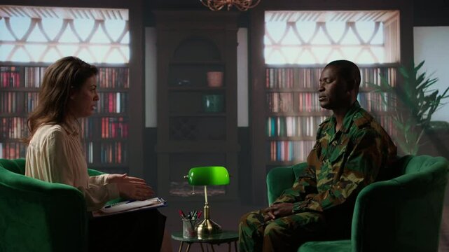 Woman therapist helping war veteran with exercises to treat traumatic depression, soldier opening up about horror combat scenes lived by his company. Psychotherapy session with counselor. Camera A.