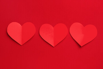 Red paper hearts on color background. Valentine's Day celebration