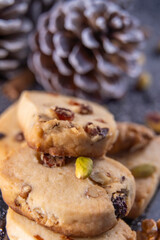 Pine nut cookies on black and white background with pine cones next to them kitchen concept