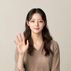 Fototapeta premium Asian young female waving with smile in casual attire