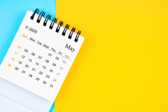 May 2025, Monthly desk calendar for 2025 year on yellow and blue color background.