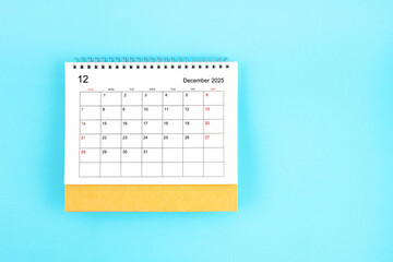 December 2025, Monthly desk calendar for 2025 year on blue background.