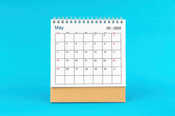 May 2025, Monthly desk calendar for 2025 year on Blue background.